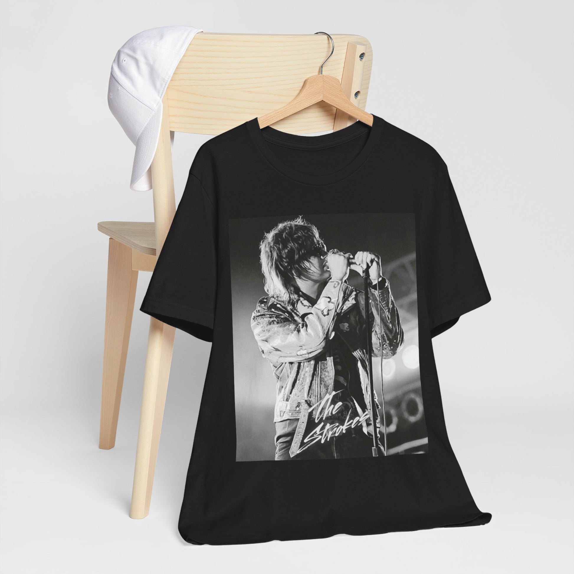 A black graphic t-shirt featuring a vintage graphic related to The Strokes' 'Last Nite' song or era.