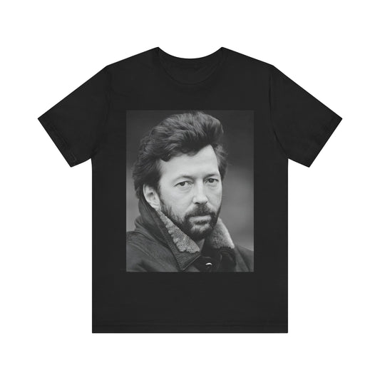 A black graphic t-shirt featuring a 70s rock aesthetic graphic of Eric Clapton.