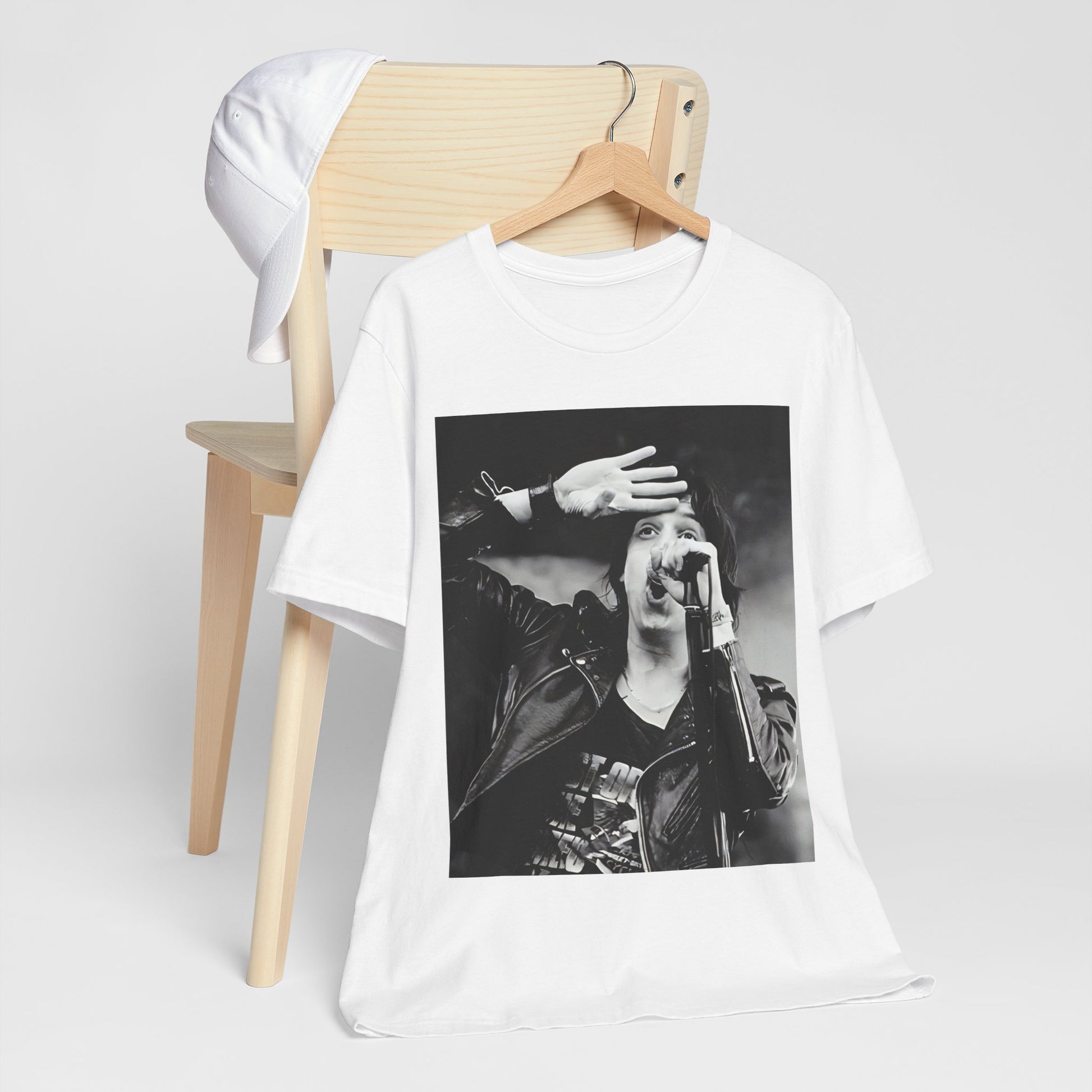 A black graphic t-shirt featuring a black and white portrait photo of The Strokes band.
