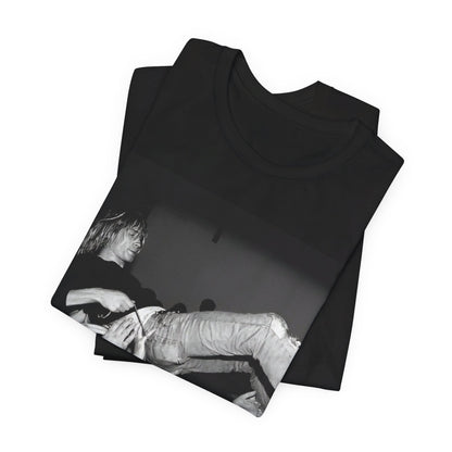 A black graphic t-shirt featuring a 90s graphic or photo of Kurt Cobain from Nirvana stage diving.