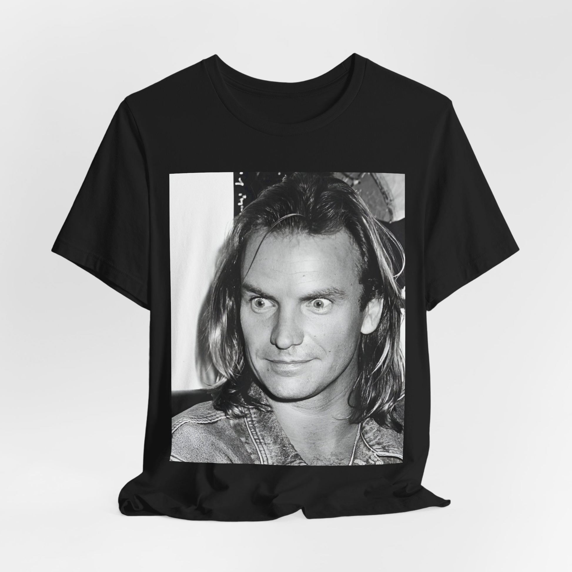 A black graphic t-shirt featuring a retro graphic related to Sting's 'Synchronicity' album era.