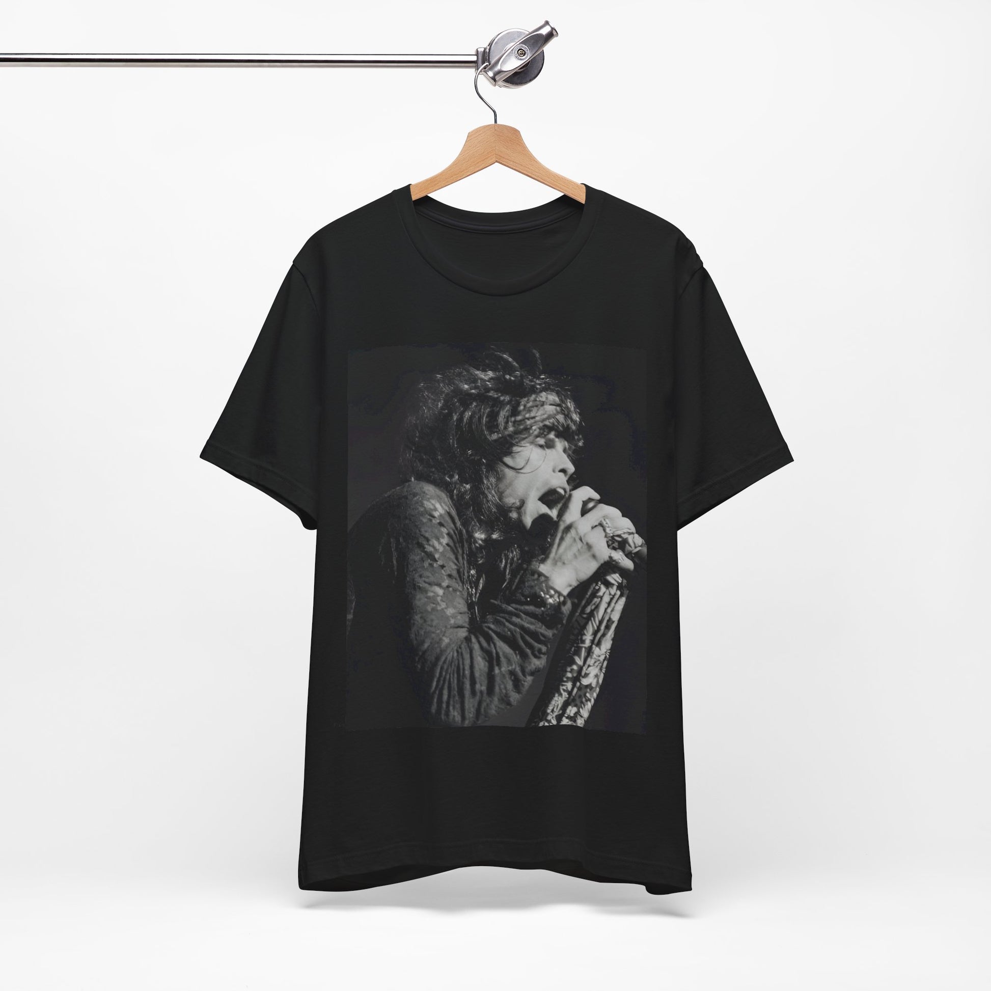 A black graphic t-shirt featuring a retro 70s-style illustration or photo of Aerosmith, designed to evoke their 'On Tour' presence, possibly with band members on stage or tour bus imagery.