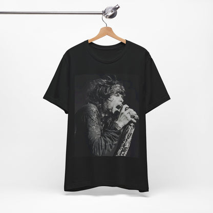 A black graphic t-shirt featuring a retro 70s-style illustration or photo of Aerosmith, designed to evoke their 'On Tour' presence, possibly with band members on stage or tour bus imagery.