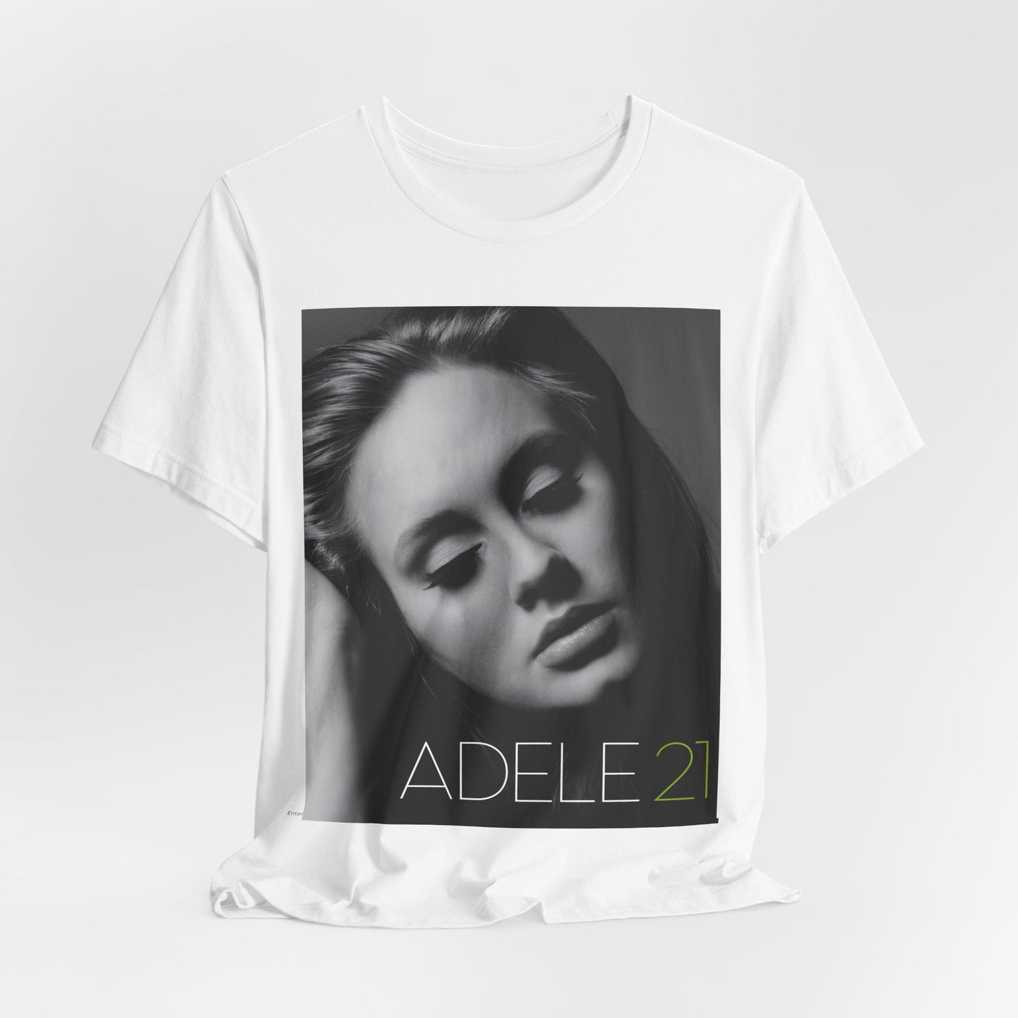 A black graphic t-shirt featuring the album cover art for Adele's '21' album, showing a close-up portrait of her with a contemplative expression.