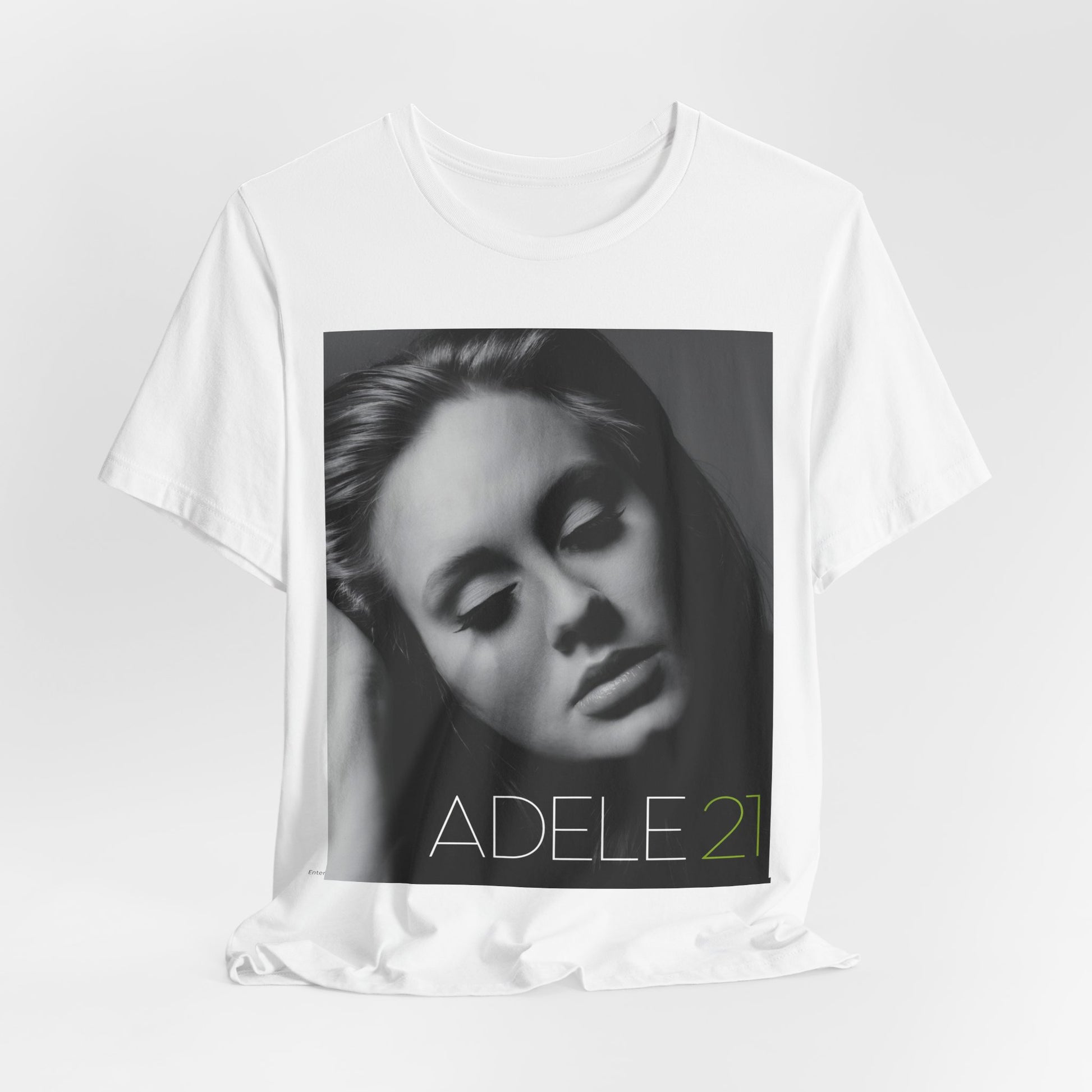 A black graphic t-shirt featuring the album cover art for Adele's '21' album, showing a close-up portrait of her with a contemplative expression.