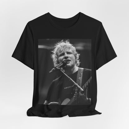 A black graphic t-shirt featuring a black and white photo of Ed Sheeran performing live.
