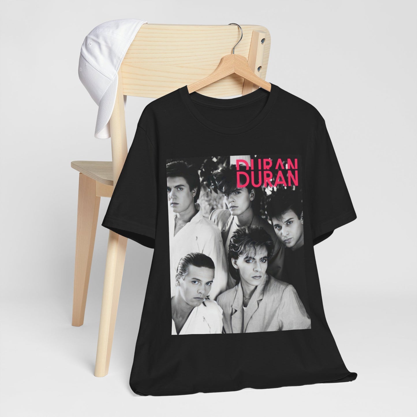 A black graphic t-shirt featuring a black and white graphic or photo of Duran Duran, designed with an 80s retro aesthetic.