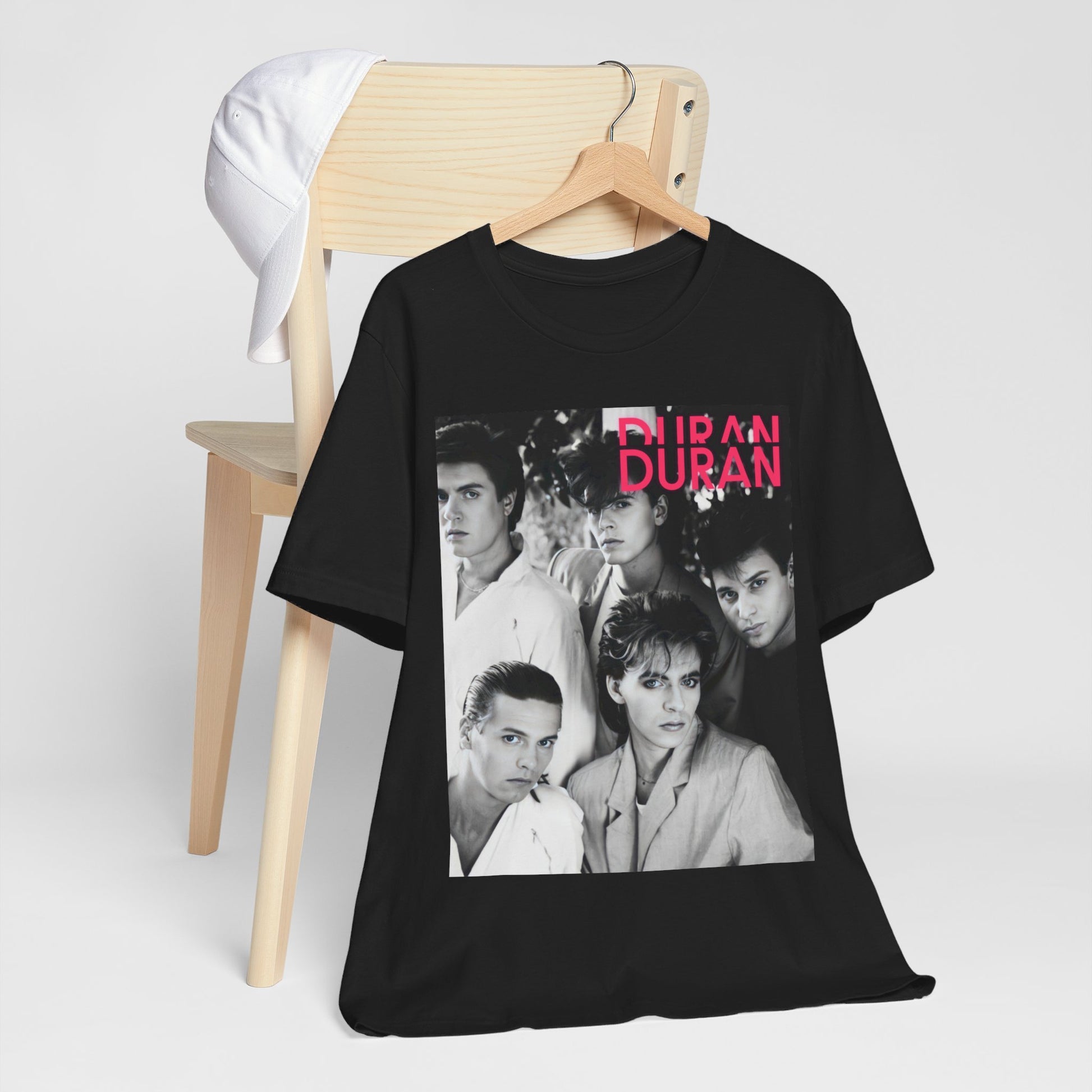 A black graphic t-shirt featuring a black and white graphic or photo of Duran Duran, designed with an 80s retro aesthetic.