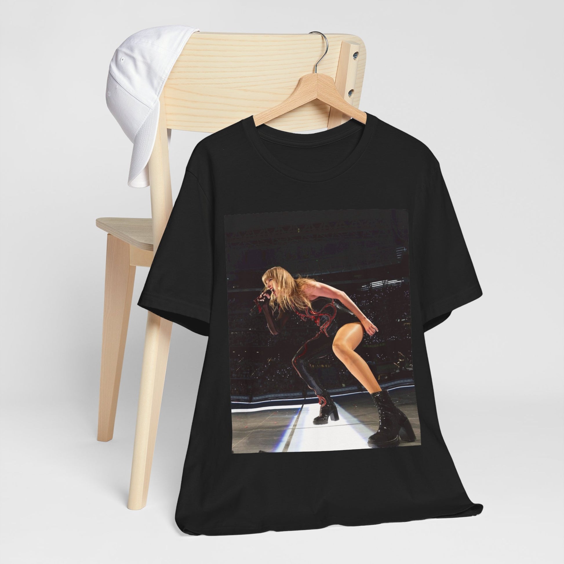 A black graphic t-shirt featuring a fierce graphic of Taylor Swift on stage.