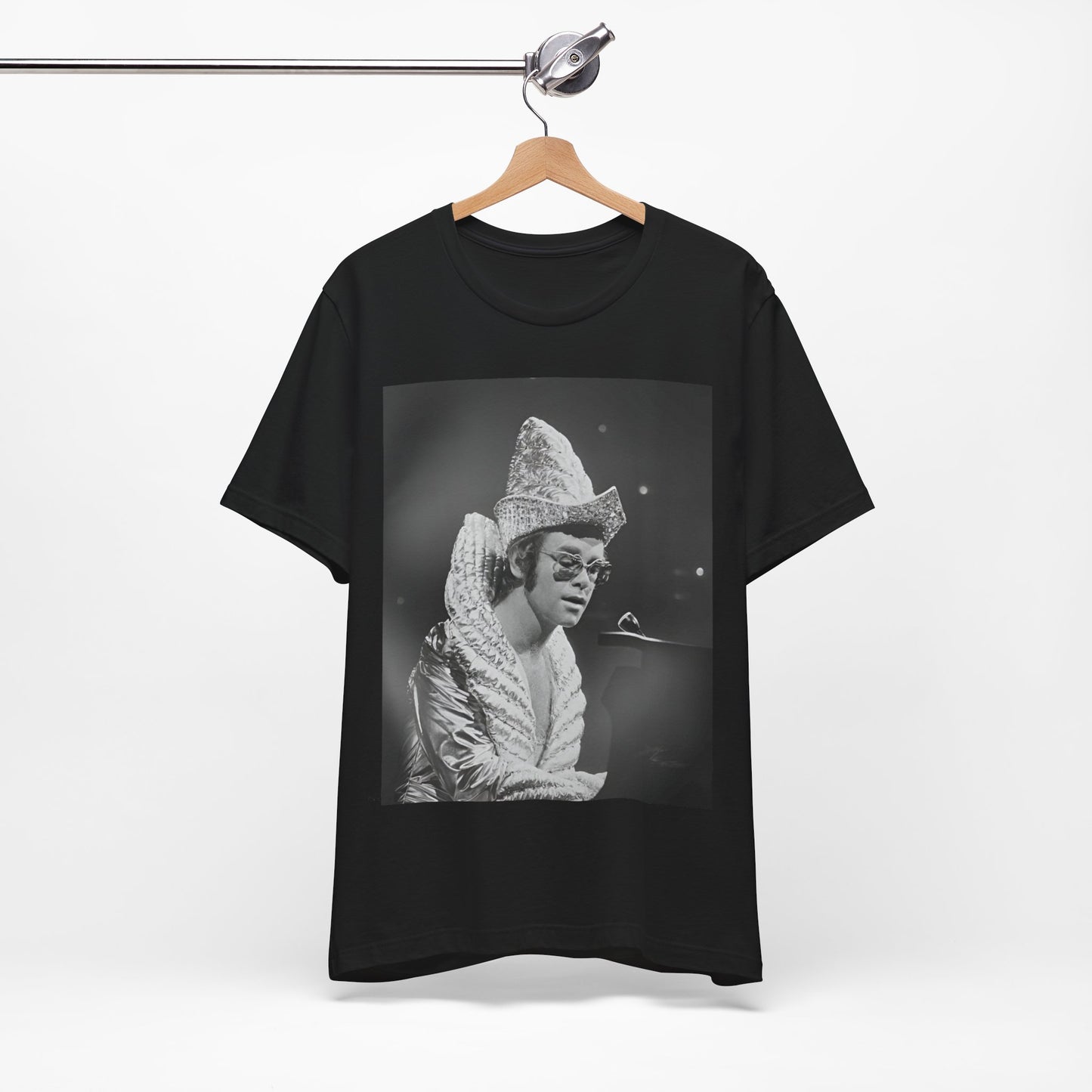 A black graphic t-shirt featuring a 70s pop aesthetic graphic of Elton John.