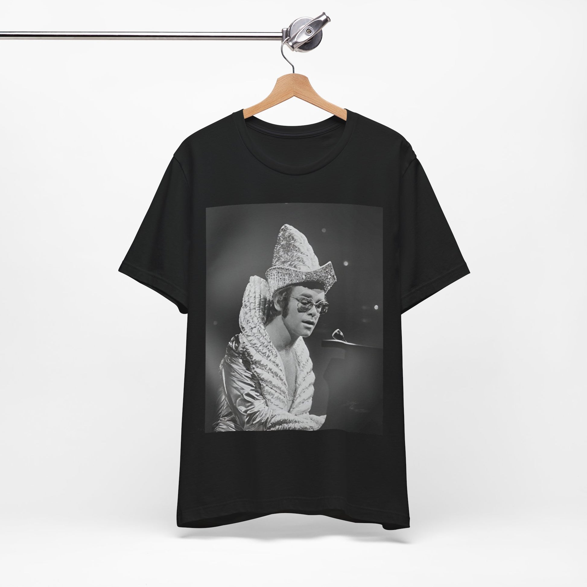 A black graphic t-shirt featuring a 70s pop aesthetic graphic of Elton John.