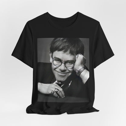 A black graphic t-shirt featuring a retro black and white photo portrait of Elton John.