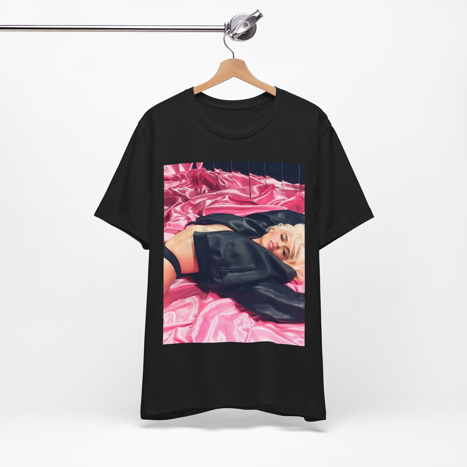 A black graphic t-shirt featuring a vintage aesthetic graphic related to Karol G's 'Tusa' era.