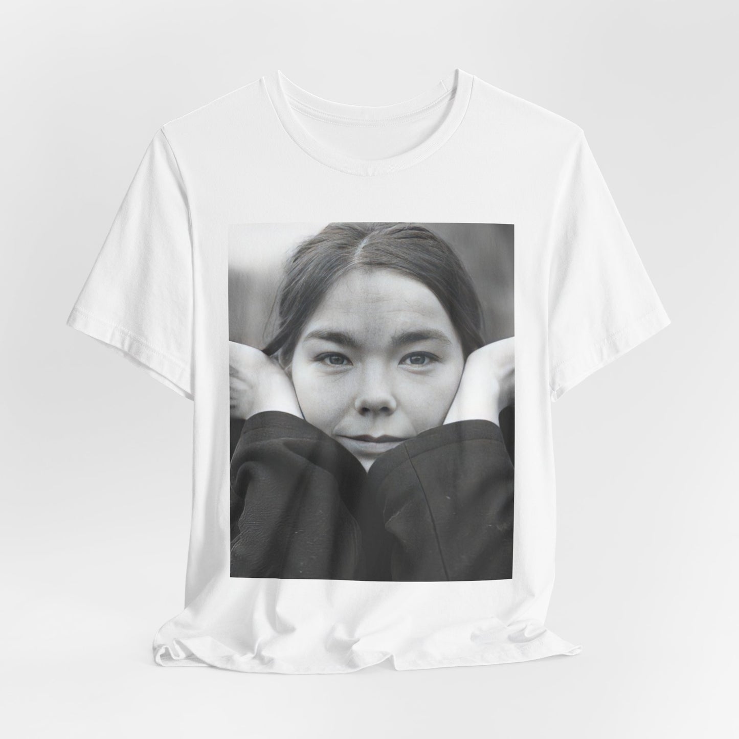 A black graphic t-shirt featuring a black and white portrait photo of Bjork.