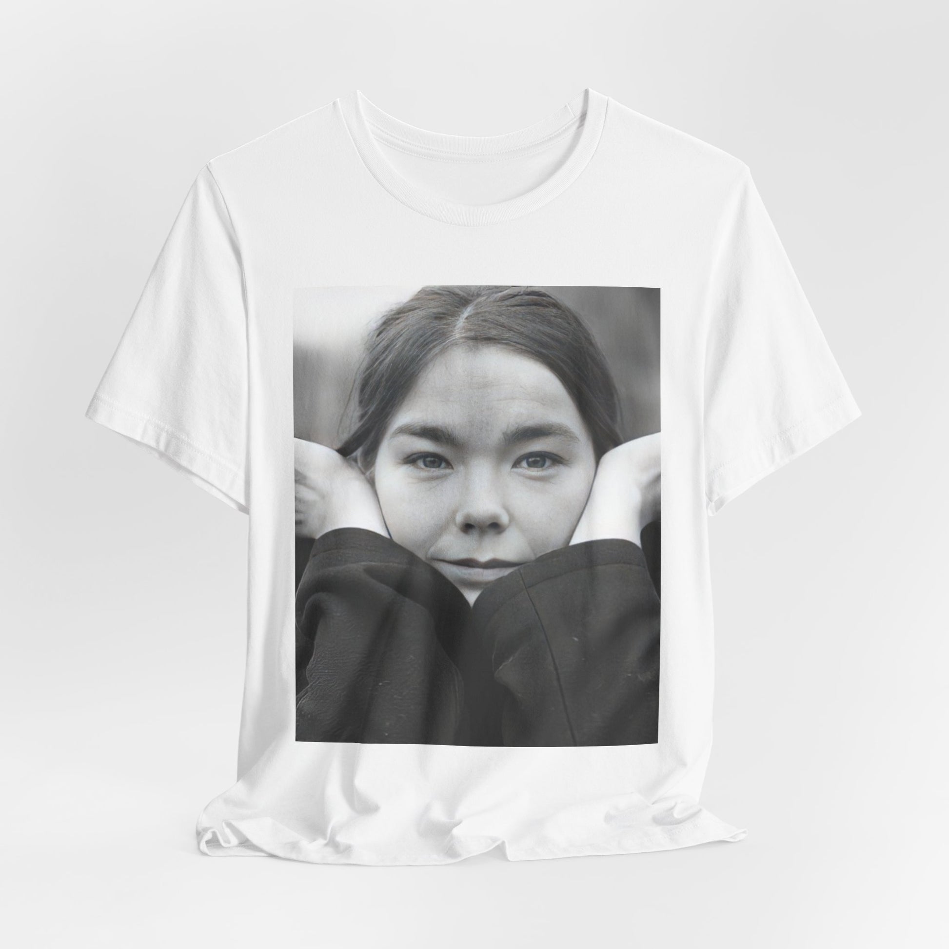 A black graphic t-shirt featuring a black and white portrait photo of Bjork.