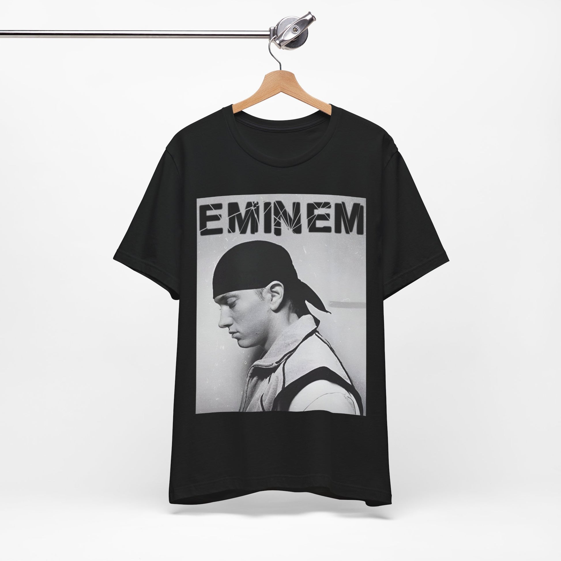 A black graphic t-shirt featuring a stylized graphic of Eminem as a modern rap legend.