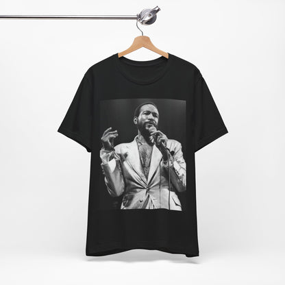 A black graphic t-shirt featuring a retro black and white photo or graphic of Marvin Gaye performing live on stage.