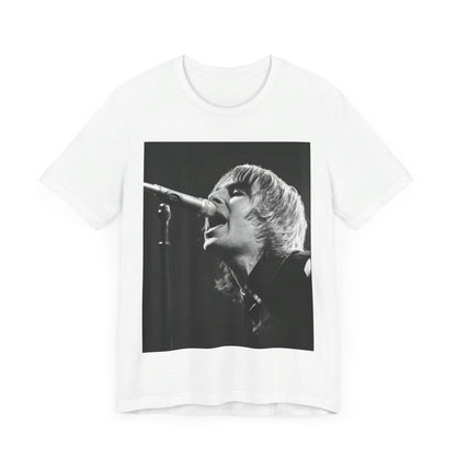 A black graphic t-shirt featuring a black and white graphic or photo of Liam Gallagher from Oasis performing live on stage.