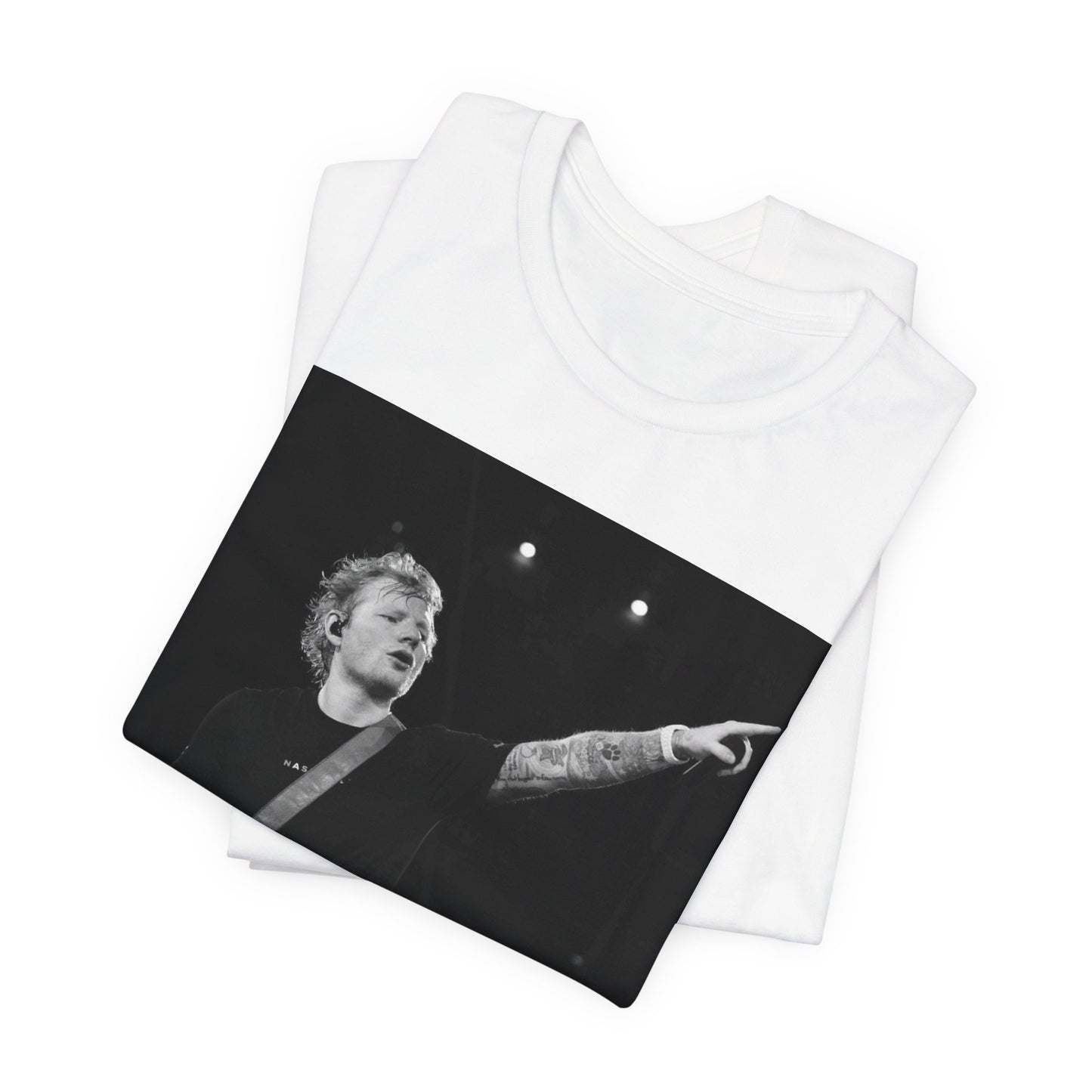 A black graphic t-shirt featuring a black and white graphic or photo of Ed Sheeran performing live on stage.
