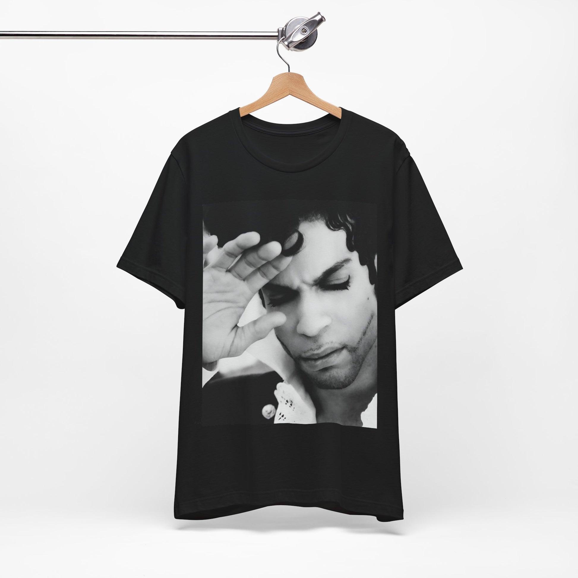 A black graphic t-shirt featuring a black and white graphic or photo portrait of Prince.