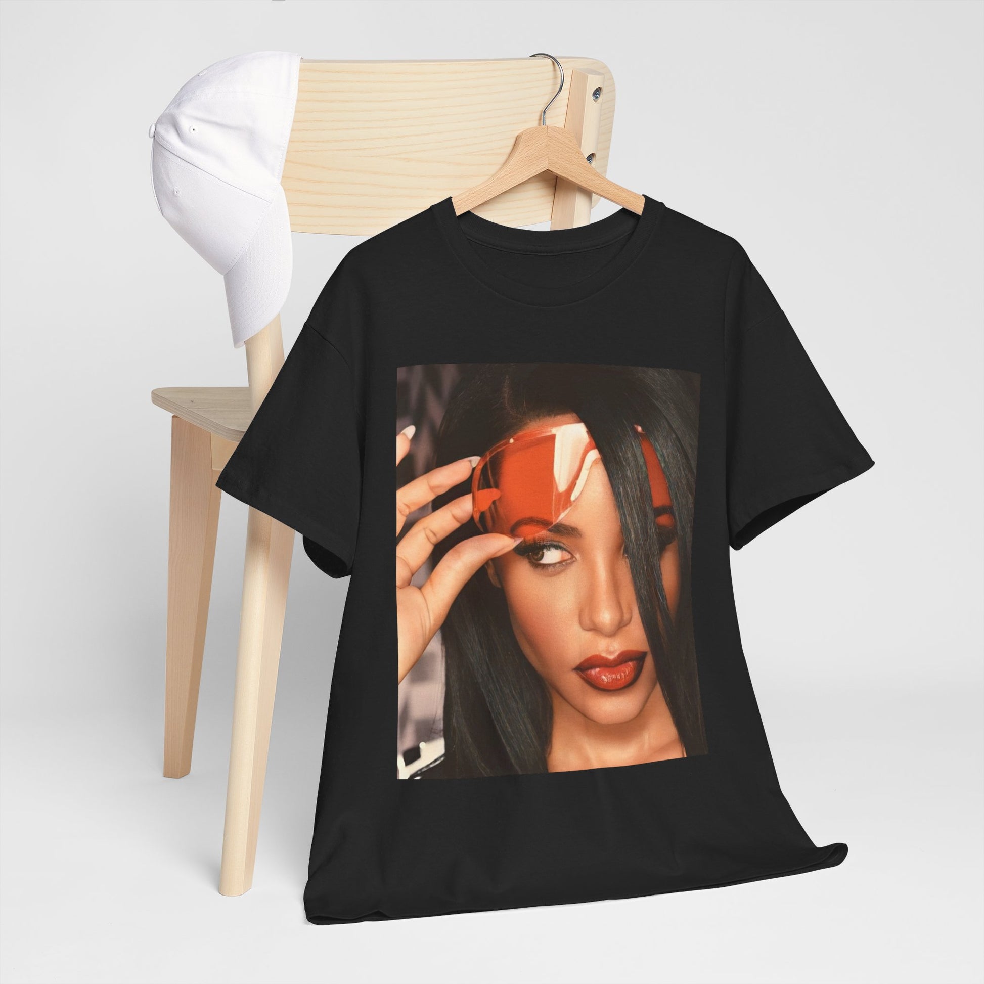 A black graphic t-shirt featuring a 90s hip hop tribute graphic of Aaliyah.