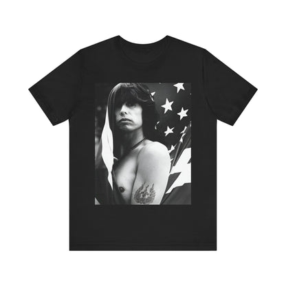 A black graphic t-shirt featuring a retro 70s-style illustration or photo of Aerosmith, integrated with elements of the American flag.