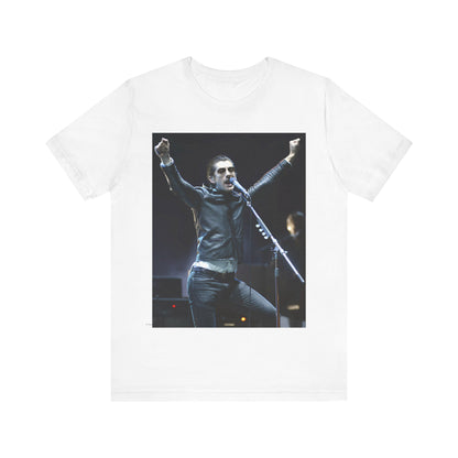 A black graphic t-shirt featuring a graphic or photo of Arctic Monkeys performing live on stage, with a Britpop aesthetic.