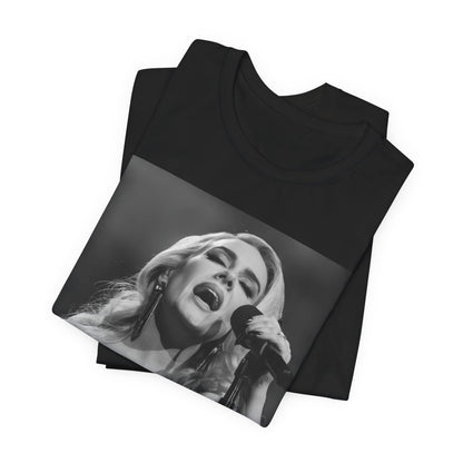 A black graphic t-shirt featuring a dynamic image of Adele performing on stage, with lighting effects, likely from her 'One Night Only' concert special.