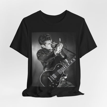 A black graphic t-shirt featuring a dynamic black and white graphic or photo of Arctic Monkeys performing live, emphasizing energy.