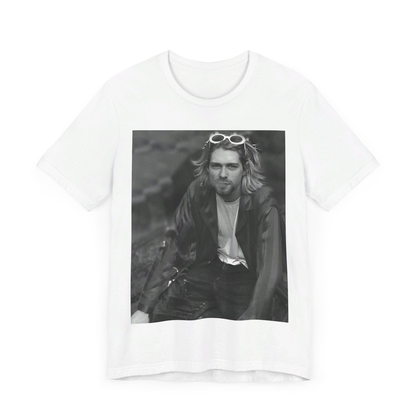 A black graphic t-shirt featuring a 90s black and white photo portrait of Kurt Cobain from Nirvana.