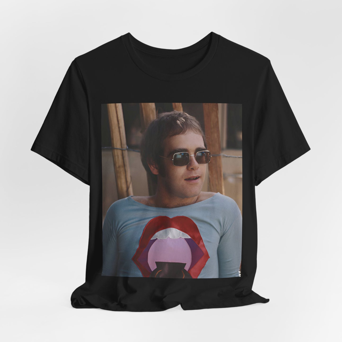 A black graphic t-shirt featuring a classic graphic related to Elton John's 'Tiny Dancer' song or era.