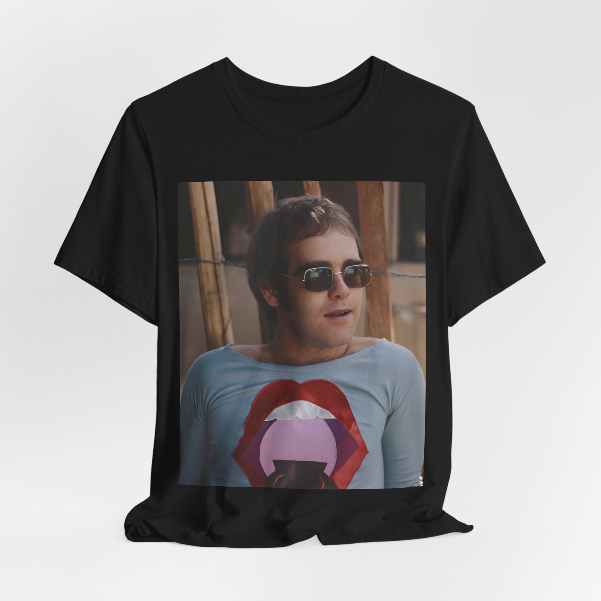 A black graphic t-shirt featuring a classic graphic related to Elton John's 'Tiny Dancer' song or era.