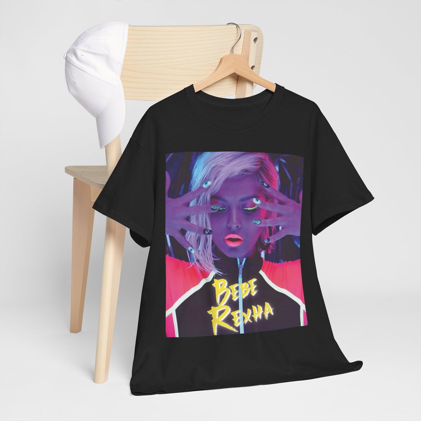 A black graphic t-shirt featuring a stylized graphic of Bebe Rexha, designed with a modern pop aesthetic.