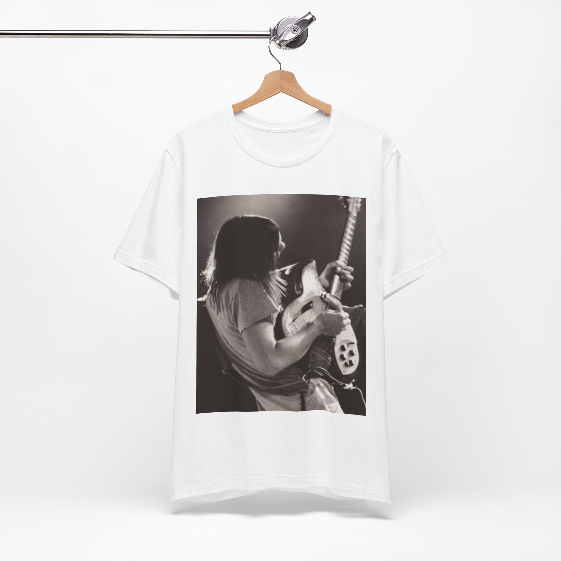 A black graphic t-shirt featuring a black and white graphic or photo of Tame Impala performing live on stage.
