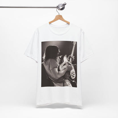 A black graphic t-shirt featuring a black and white graphic or photo of Tame Impala performing live on stage.