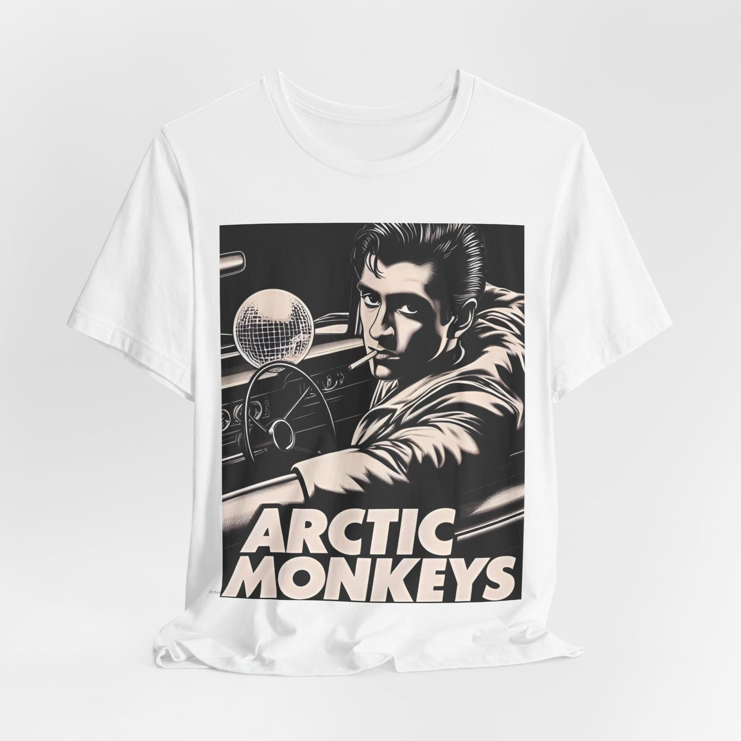 A black graphic t-shirt featuring a graphic of Arctic Monkeys from the 2000s, evoking an indie rock aesthetic.