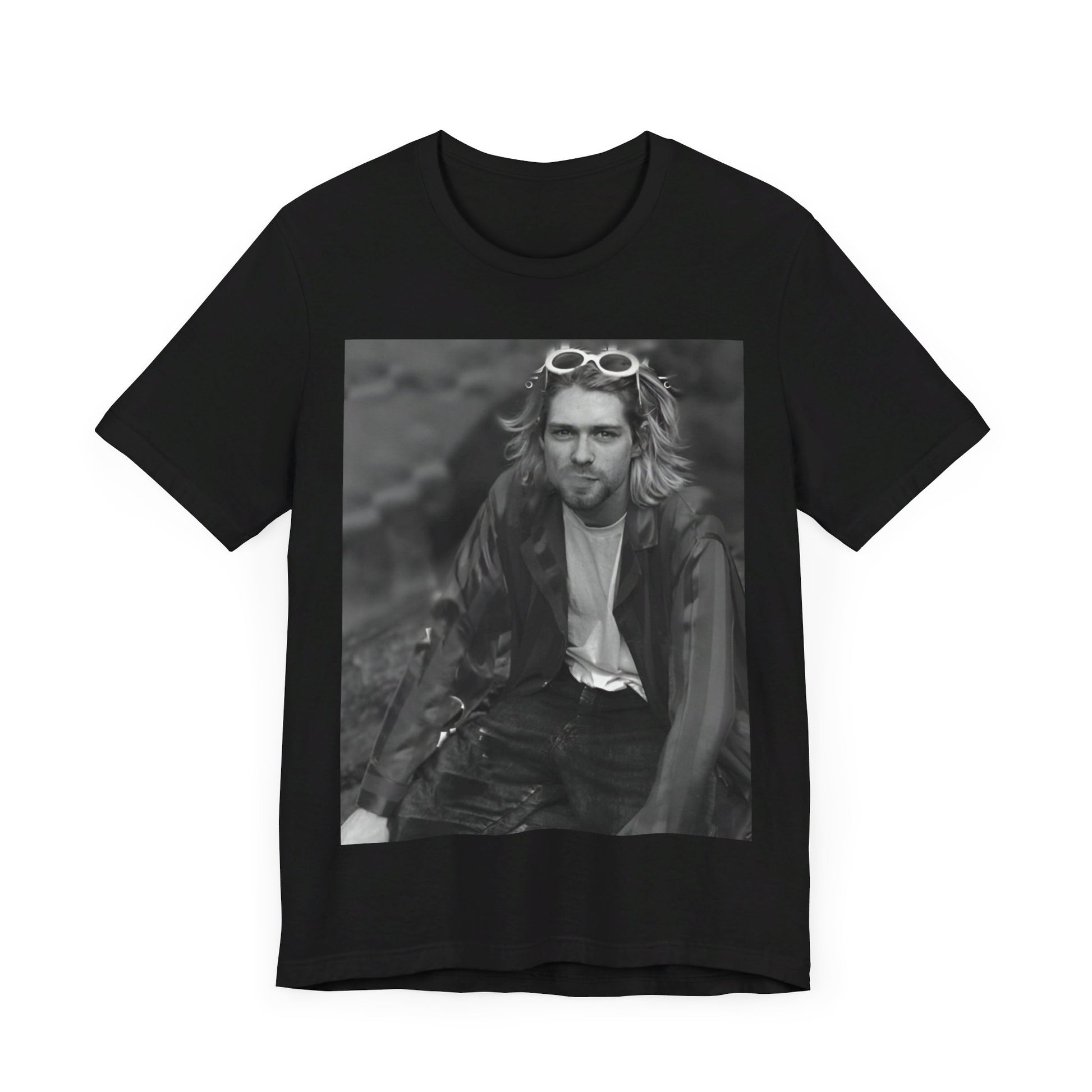 A black graphic t-shirt featuring a 90s black and white photo portrait of Kurt Cobain from Nirvana.