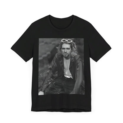 A black graphic t-shirt featuring a 90s black and white photo portrait of Kurt Cobain from Nirvana.