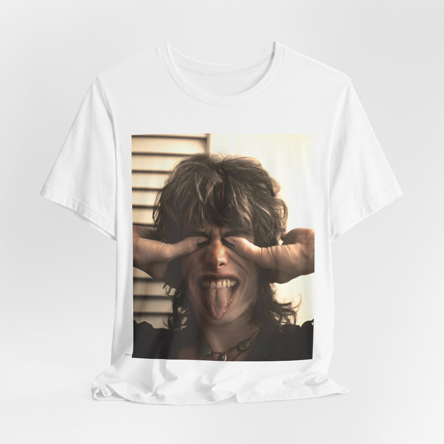 A black graphic t-shirt featuring a vintage 70s band photo of Aerosmith, showing the members in their iconic early looks.