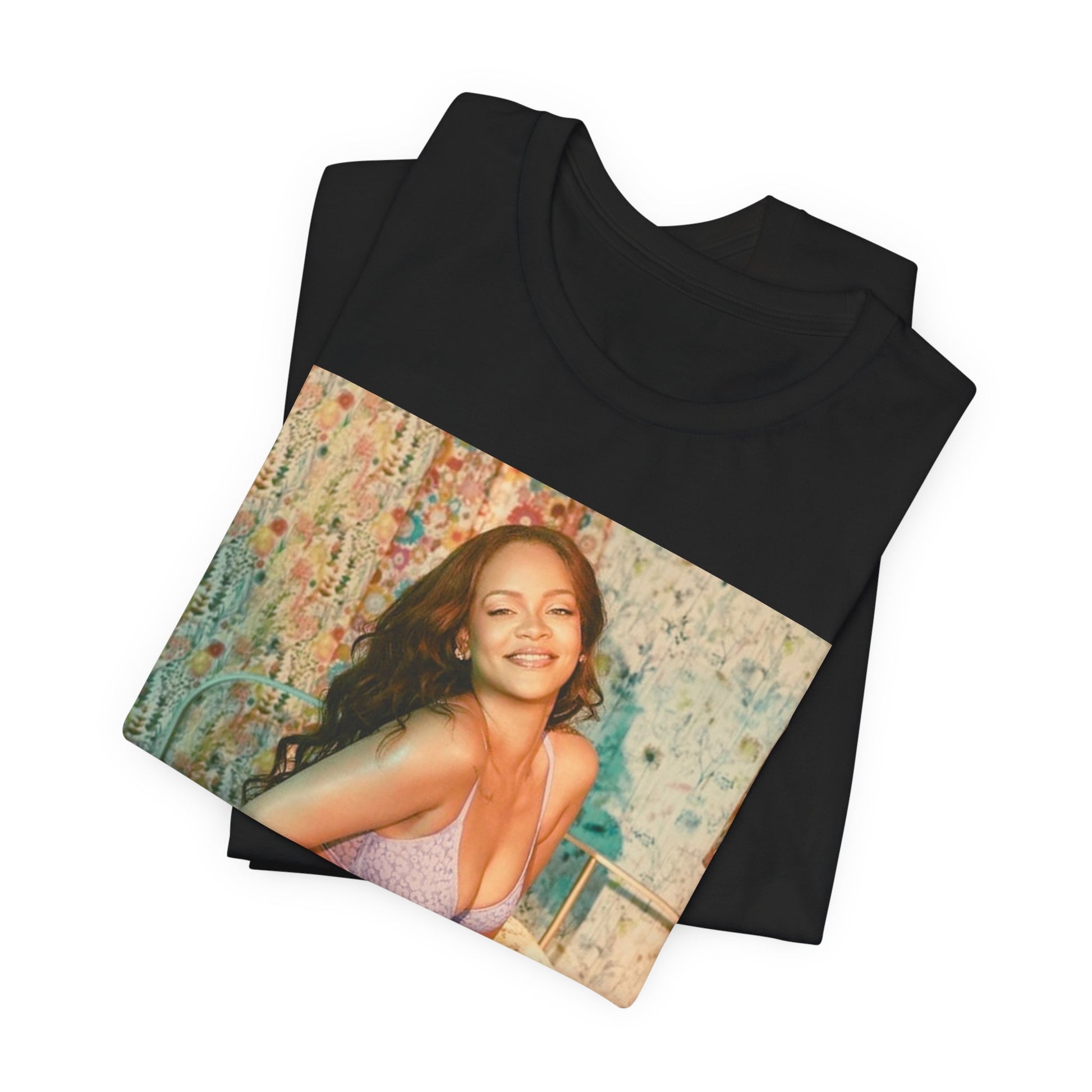 A black graphic t-shirt featuring a graphic of Rihanna with a beauty aesthetic.
