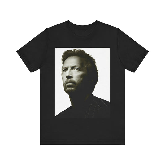 A black graphic t-shirt featuring a retro black and white portrait photo of Eric Clapton.