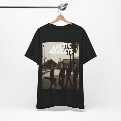 A black graphic t-shirt featuring Arctic Monkeys in a pose or setting similar to the iconic 'Abbey Road' album cover.