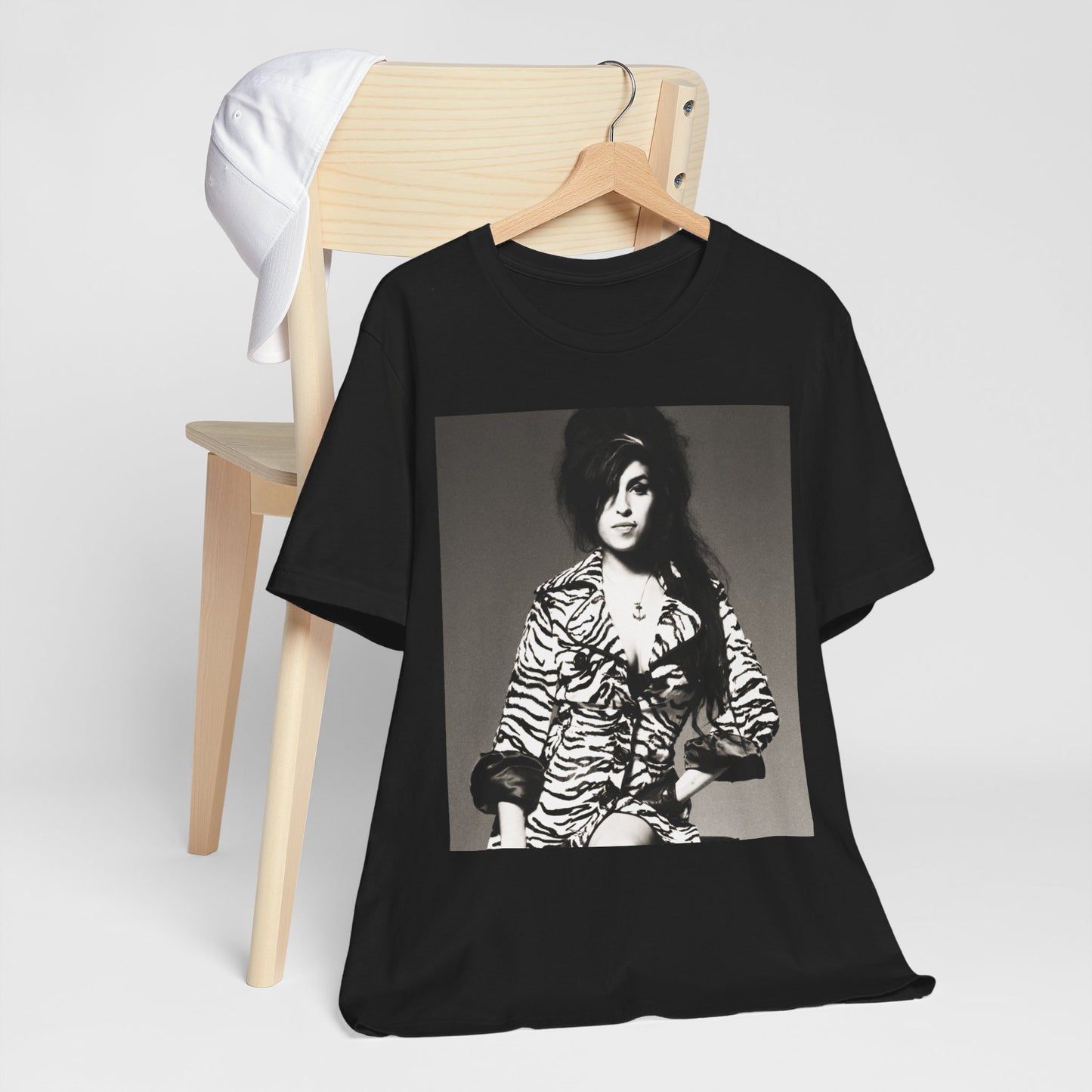 A black graphic t-shirt featuring a graphic related to Amy Winehouse's 'Back to Black' album era from 2006, possibly with album art elements.