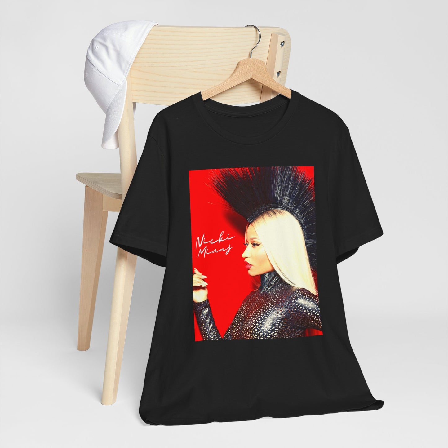 A black graphic t-shirt featuring a graphic of Nicki Minaj as a female rap pioneer.