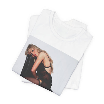 A black graphic t-shirt featuring a playful pop art style graphic of Sabrina Carpenter.