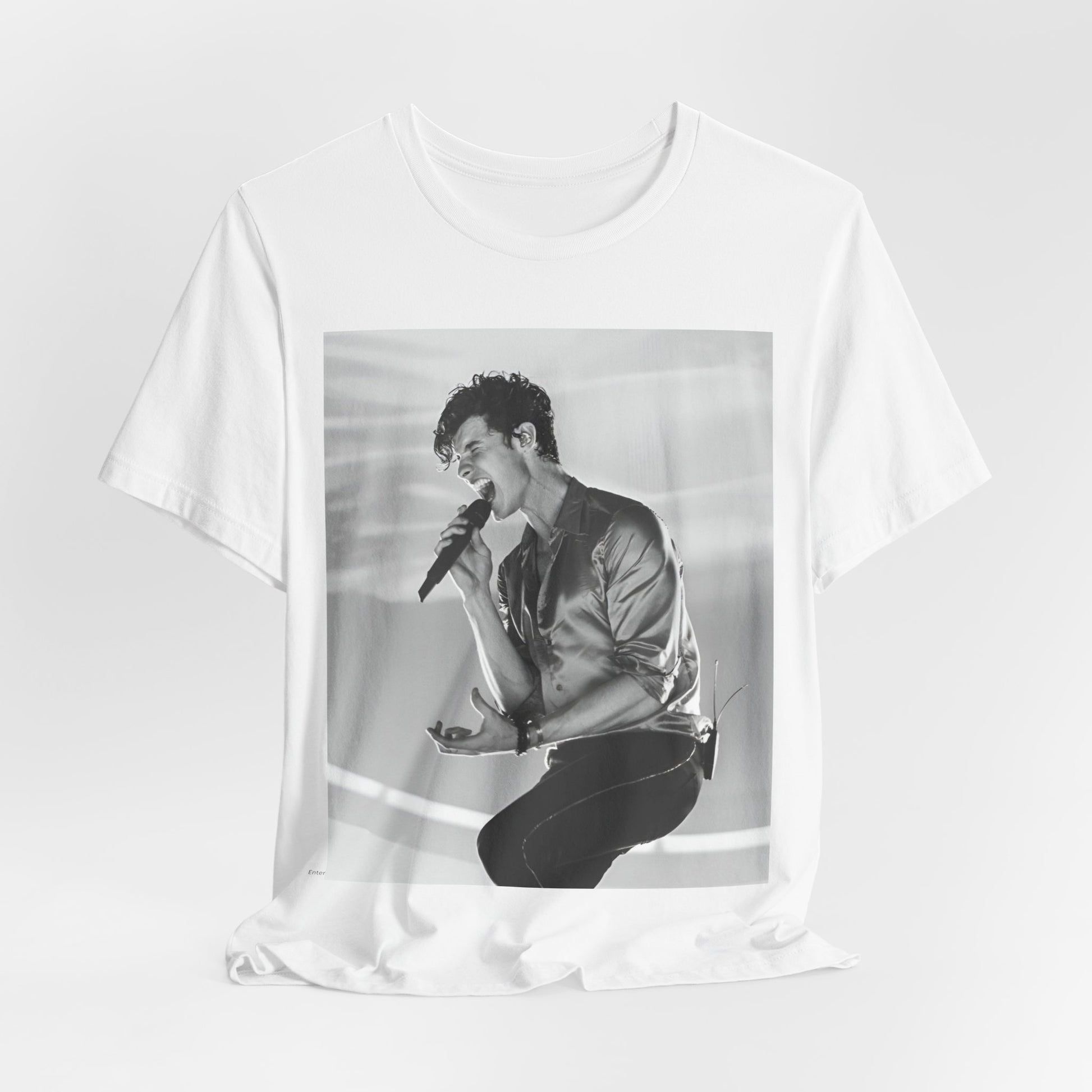 A black graphic t-shirt featuring a black and white graphic or photo of Shawn Mendes as a dreamy pop star.