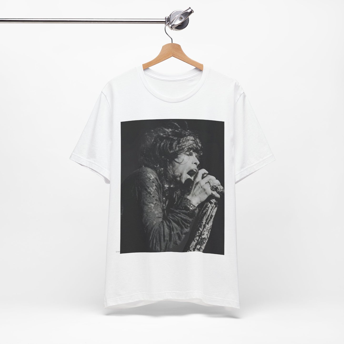 A black graphic t-shirt featuring a retro 70s-style illustration or photo of Aerosmith, designed to evoke their 'On Tour' presence, possibly with band members on stage or tour bus imagery.