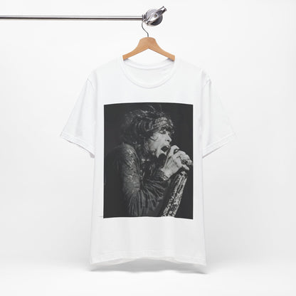 A black graphic t-shirt featuring a retro 70s-style illustration or photo of Aerosmith, designed to evoke their 'On Tour' presence, possibly with band members on stage or tour bus imagery.