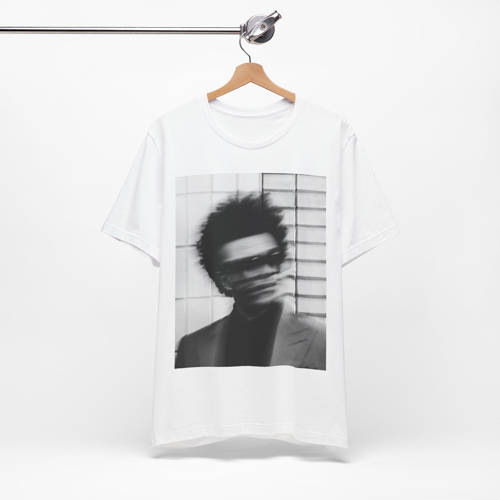 A black graphic t-shirt featuring a blurred graphic of The Weeknd from his 'After Hours' era.