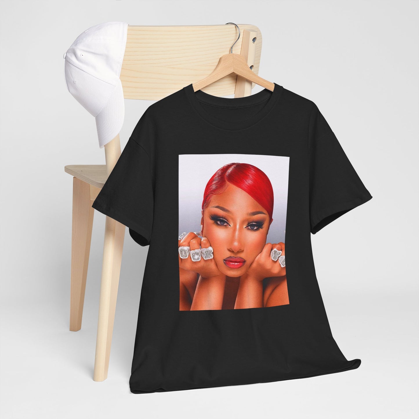 A black graphic t-shirt featuring a bold graphic of Megan Thee Stallion as a rap superstar.